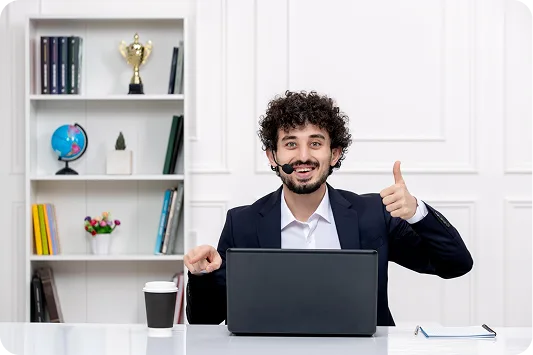 Professional man giving thumbs up while working